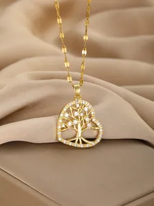 Macro shot of gold heart necklace with Tree of Life pendant and sparkling white zircons
