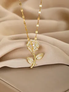 Detailed close-up of a gold rose pendant necklace with shimmering zircon stones