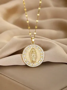Detailed view of Virgin Mary medal with halo of zircons on a golden chain and silk