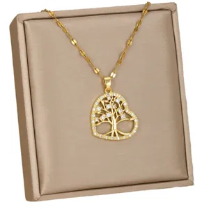 Golden heart necklace with tree of life pendant and white cubic zirconia on satin