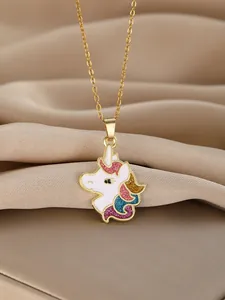 Macro detail of unicorn pendant with colorful glitter and golden chain on silk
