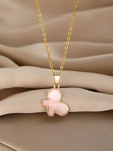 Detailed macro view of the golden chain and pink butterfly pendant on satin