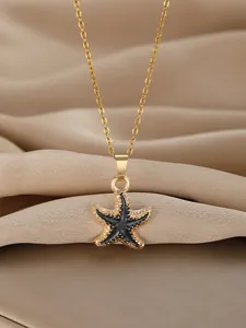 Detailed view of a gold starfish pendant necklace on an elegant champagne satin background