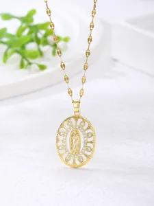Macro shot of gold Virgin Mary pendant with cubic zirconia and hollow rose detail