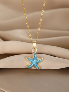 Detailed view of sky blue starfish pendant necklace on champagne satin background