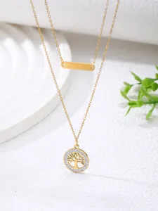 Detail of gold double-layer necklace with tree of life pendant and pavé zircons