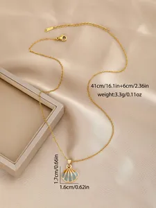Detail of gold shell pendant with grey enamel finish and S.STEEL stamp on chain
