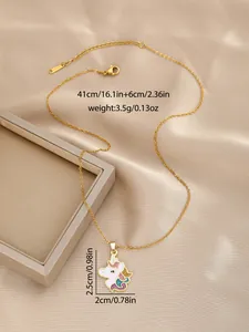 Detail of gold unicorn pendant with colorful oil drip finish on silk background