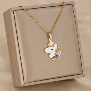 Delicate gold unicorn necklace with colorful enamel pendant on a champagne jewelry box