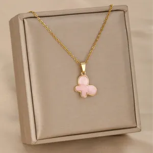 Elegant gold chain necklace with a pink butterfly pendant displayed on a satin jewelry box
