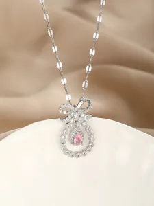 Detailed macro of S925 silver bow necklace with a pink teardrop zirconia stone