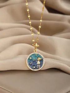 Detail of gold star and girl pendant necklace with blue enamel and crystal inlay