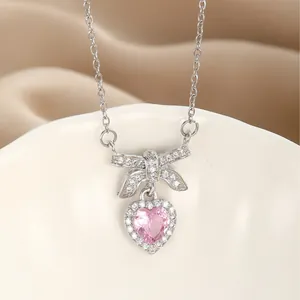 S925 silver pink heart necklace with cz bow pendant displayed on elegant silk background