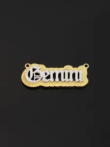 Macro detail of the Gemini zodiac necklace featuring a two-tone gold and silver gothic design