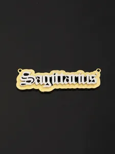 Macro detail of Sagittarius zodiac pendant with layered gold glitter and silver metal