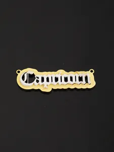 Macro detail of Capricorn zodiac charm with gold glitter and silver metallic gothic lettering