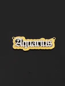Macro detail of golden glitter Aquarius zodiac pendant with gothic lettering and double layers