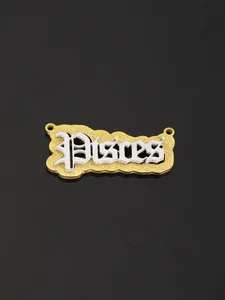 Macro detail of Pisces zodiac pendant with gold frosted base and silver gothic letters