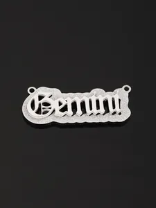 Detailed view of silver Gemini zodiac pendant with matte texture and gothic lettering
