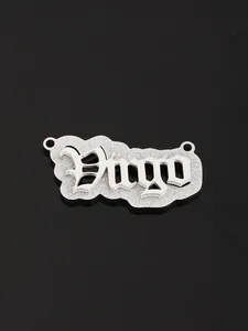 Detailed macro shot of a silver Virgo constellation pendant with a gothic font design