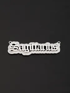 Macro detail of silver Sagittarius zodiac pendant with double-layered metal texture