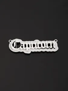 Macro detail of Capricorn zodiac necklace pendant in gothic font with silver finish