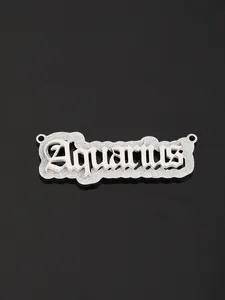 Detailed view of Aquarius gothic pendant with glitter texture on black reflective surface