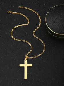 Detail shot of golden cross pendant with engraved Lord's Prayer on a cuban link chain
