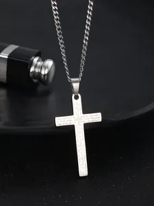 Detail of silver stainless steel cross pendant featuring engraved English Lord's Prayer text
