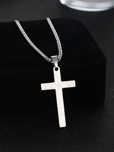 Detailed macro view of silver cross pendant with micro-engraved Lord's Prayer text