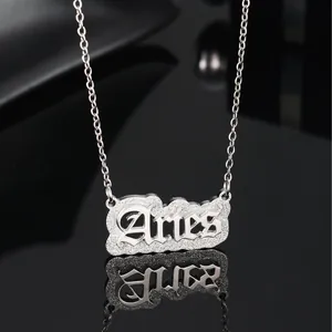 Silver Aries zodiac necklace with gothic lettering on a black reflective background