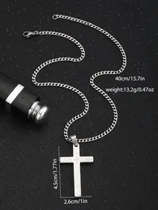 Macro shot of stainless steel cross pendant with Lord's Prayer engraving and 40cm Cuban chain