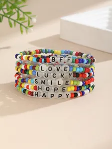 Detalle del set de pulseras de cuentas de colores con letras blancas y detalles dorados