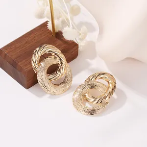 Vintage gold hollow double-ring earrings with elegant twisted rope texture and matte finish