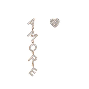 Detailed close-up of asymmetrical rose gold heart and AMORE letter earrings with zircon