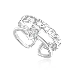 Macro detail of silver adjustable ring featuring a star pendant and Cuban chain texture