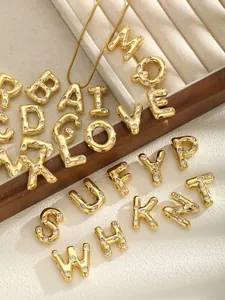Detailed close-up of golden alphabet pendant A with sparkling pavé zircons on chain
