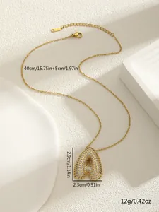 Macro detail of gold 3D bubble letter A pendant with sparkling crystal inlay