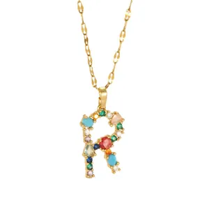 Gold letter R pendant necklace with multi-colored gemstones on a fine link chain