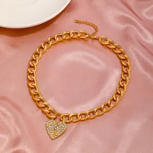Vintage gold chunky chain necklace with a sparkling rhinestone heart locket pendant
