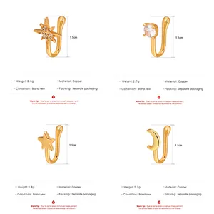 Detailed view of four copper nose clips with star and moon designs in gold finish