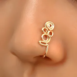 Detail of a non-pierced gold spiral nose clip with flower design on female nostril