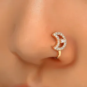 Macro shot of gold moon nose clip with zircon inlay for non-pierced wearing style