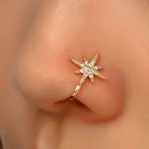 Detail of gold star non-piercing nose cuff with sparkling zircon stones in macro view