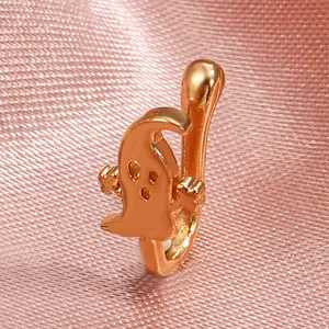 Close-up of rose gold ghost-shaped non-piercing nose ring on pink silk background