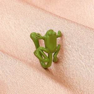 Detailed close-up of a vintage green frog-shaped ear cuff with zircon inlay details