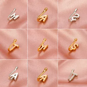 U-shaped non-piercing copper nose rings with zircon letters on pink silk background
