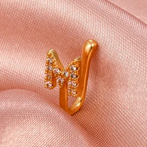 Detailed macro view of gold-plated letter M non-piercing nose clip with cubic zirconia