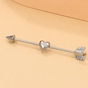 Punk style stainless steel industrial barbell featuring heart and arrow piercing design
