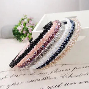 Elegant beaded crystal headbands in six pastel colors on a stylish decorative tray